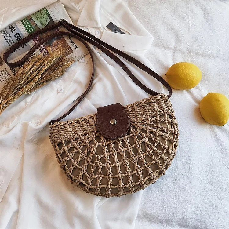 A stylish one-shoulder straw saddle bag with a zipper closure, perfect for modern British consumers.