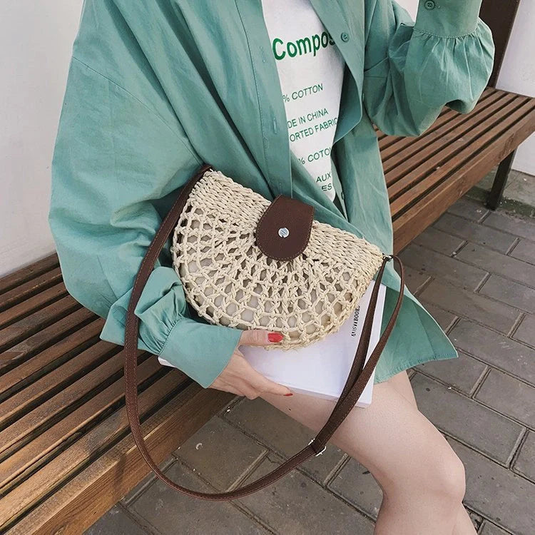 A stylish one-shoulder straw saddle bag with a zipper closure, perfect for modern British consumers.