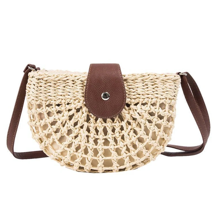 A stylish one-shoulder straw saddle bag with a zipper closure, perfect for modern British consumers.