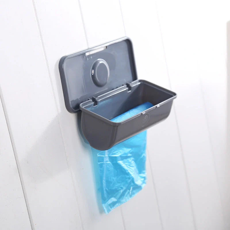 Wall-mounted plastic garbage bag holder in white, grey, or pink for kitchen organisation
