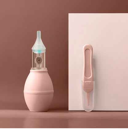 Infant silicone nasal aspirator pump in pink and green, designed for gentle cold relief