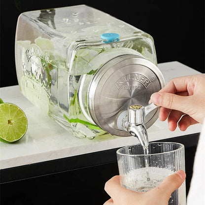 A stylish glass beverage dispenser with a sleek faucet, perfect for serving chilled drinks at home or events.