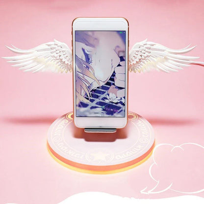 Stylish wireless charging dock with unfolding angel wings, providing fast and safe charging for compatible smartphones