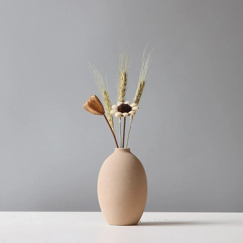 Ceramic vase in various colours, including brown, black, green, and orange, showcasing a minimalist Scandinavian design that is perfect for living room decor.