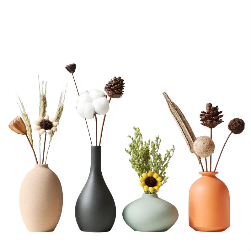 Ceramic vase in various colours, including brown, black, green, and orange, showcasing a minimalist Scandinavian design that is perfect for living room decor.