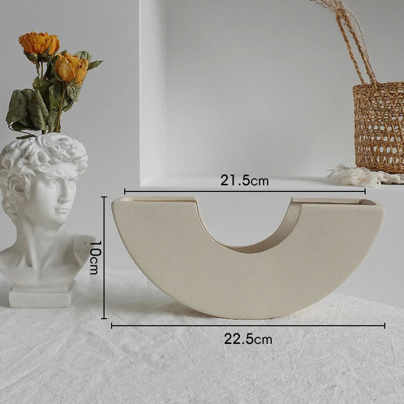 Rustic ceramic vase with matte textured finish for displaying dried flower arrangements in a Scandinavian-inspired home decor setting