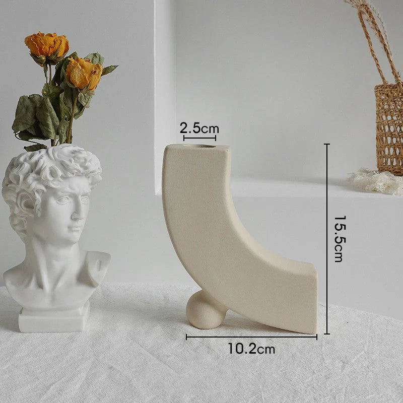 Rustic ceramic vase with matte textured finish for displaying dried flower arrangements in a Scandinavian-inspired home decor setting