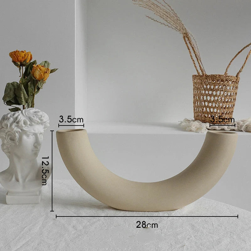 Rustic ceramic vase with matte textured finish for displaying dried flower arrangements in a Scandinavian-inspired home decor setting