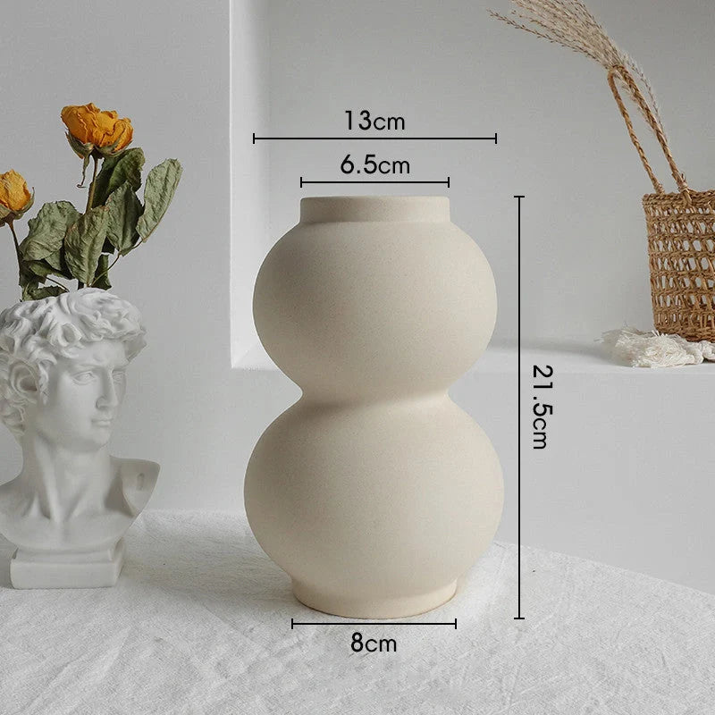 Rustic ceramic vase with matte textured finish for displaying dried flower arrangements in a Scandinavian-inspired home decor setting