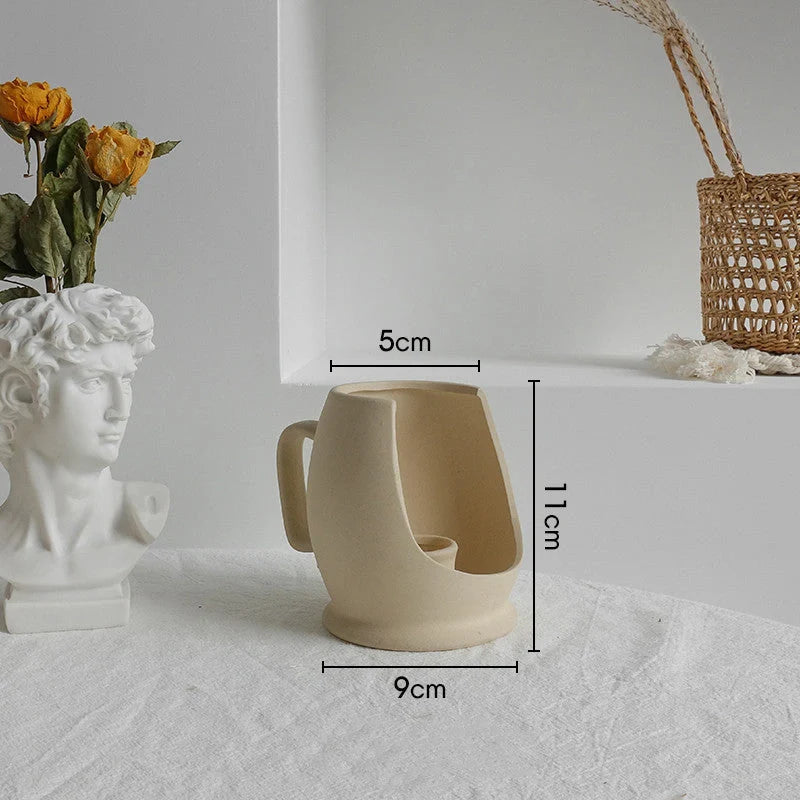 Rustic ceramic vase with matte textured finish for displaying dried flower arrangements in a Scandinavian-inspired home decor setting