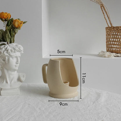 Rustic ceramic vase with matte textured finish for displaying dried flower arrangements in a Scandinavian-inspired home decor setting