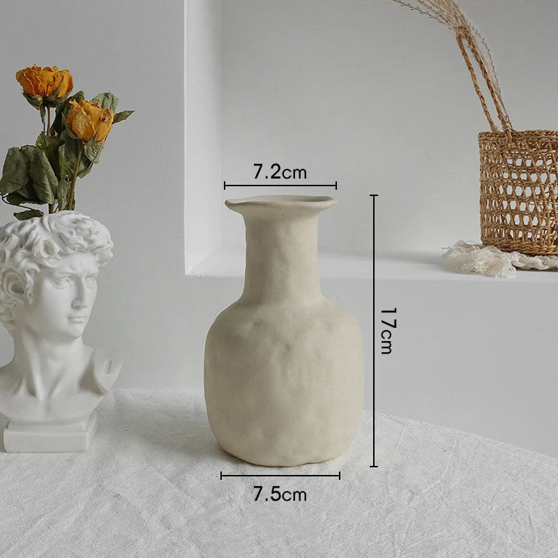 Rustic ceramic vase with matte textured finish for displaying dried flower arrangements in a Scandinavian-inspired home decor setting