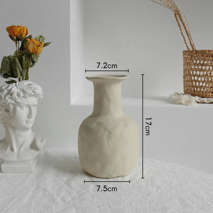 Rustic ceramic vase with matte textured finish for displaying dried flower arrangements in a Scandinavian-inspired home decor setting