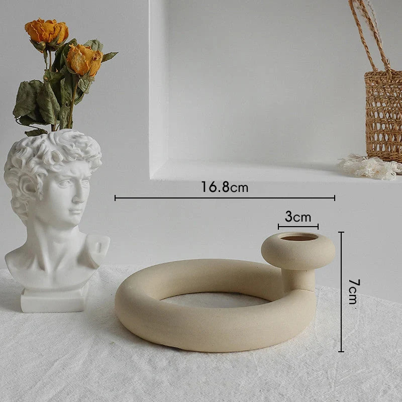 Rustic ceramic vase with matte textured finish for displaying dried flower arrangements in a Scandinavian-inspired home decor setting