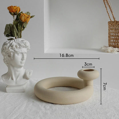 Rustic ceramic vase with matte textured finish for displaying dried flower arrangements in a Scandinavian-inspired home decor setting