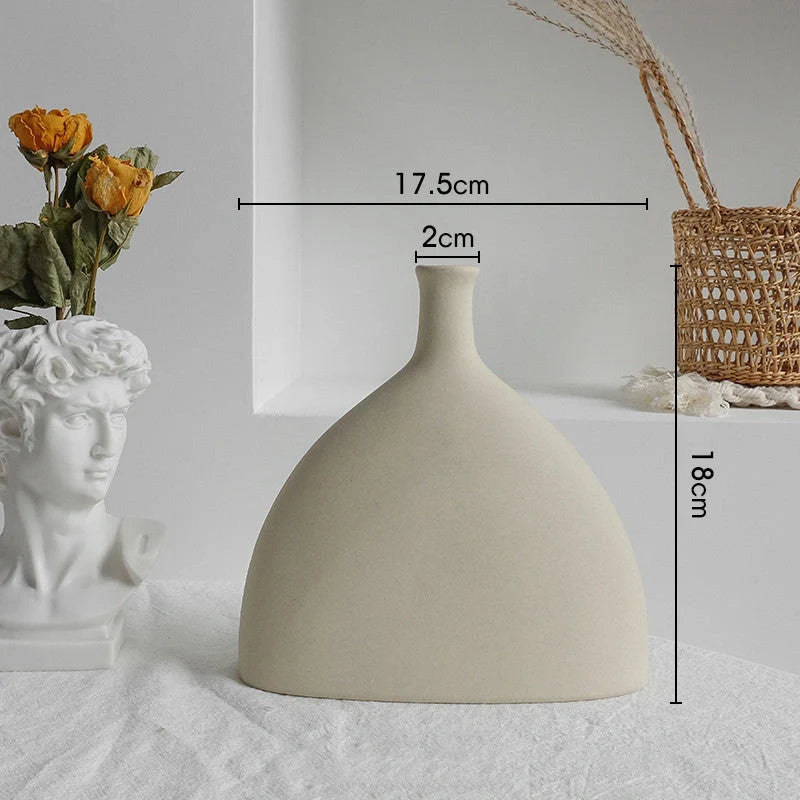 Rustic ceramic vase with matte textured finish for displaying dried flower arrangements in a Scandinavian-inspired home decor setting