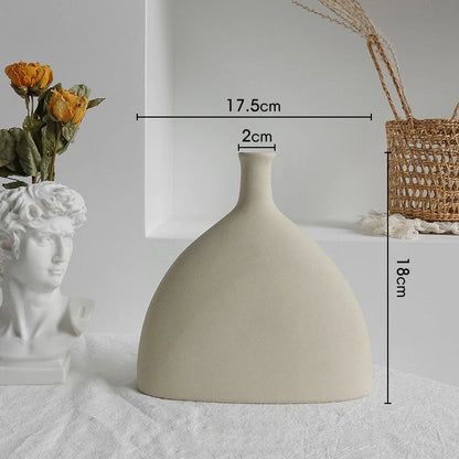 Rustic ceramic vase with matte textured finish for displaying dried flower arrangements in a Scandinavian-inspired home decor setting
