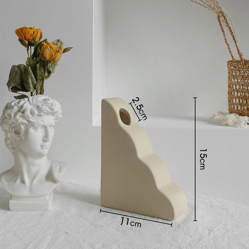 Rustic ceramic vase with matte textured finish for displaying dried flower arrangements in a Scandinavian-inspired home decor setting