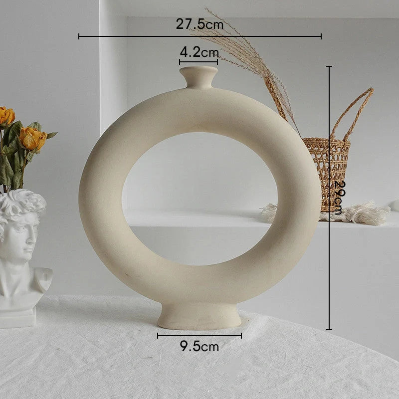 Rustic ceramic vase with matte textured finish for displaying dried flower arrangements in a Scandinavian-inspired home decor setting