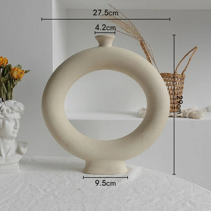 Rustic ceramic vase with matte textured finish for displaying dried flower arrangements in a Scandinavian-inspired home decor setting