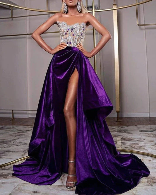 A glamorous purple sequin cocktail dress with a small train, sleeveless design, and rhinestone embellishments, suitable for special occasions in the UK.