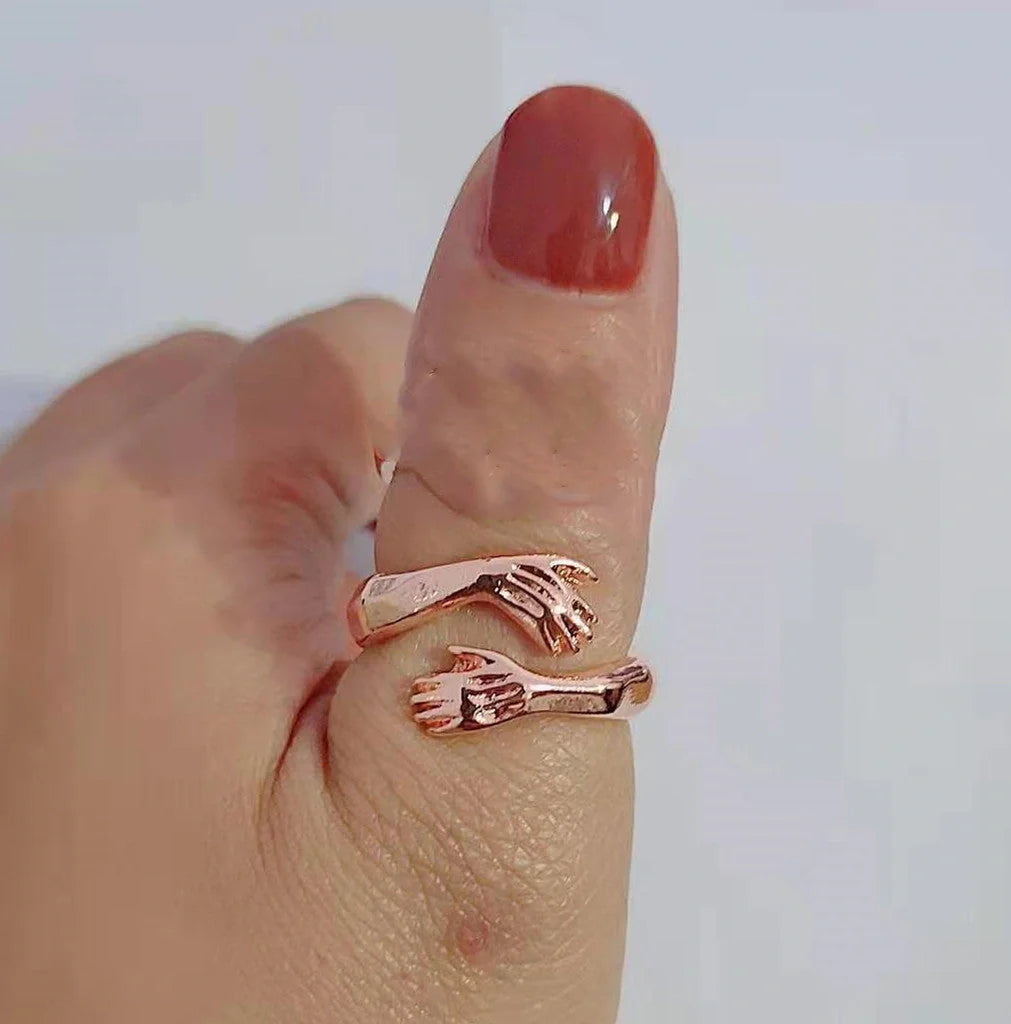 Elegant Adjustable Love Hands Embracing Ring in gold and silver, a perfect symbol of affection