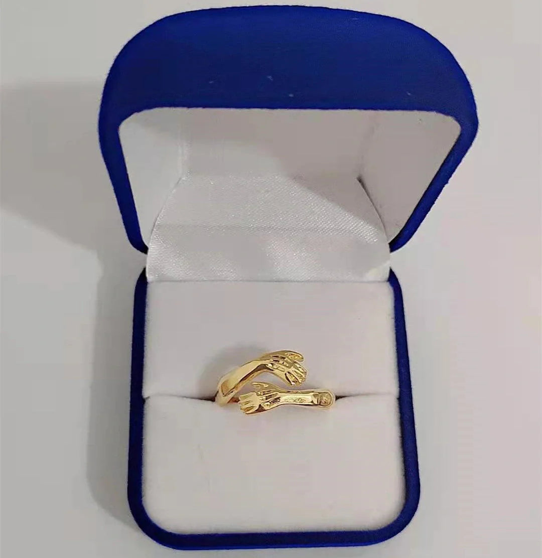 Elegant Adjustable Love Hands Embracing Ring in gold and silver, a perfect symbol of affection