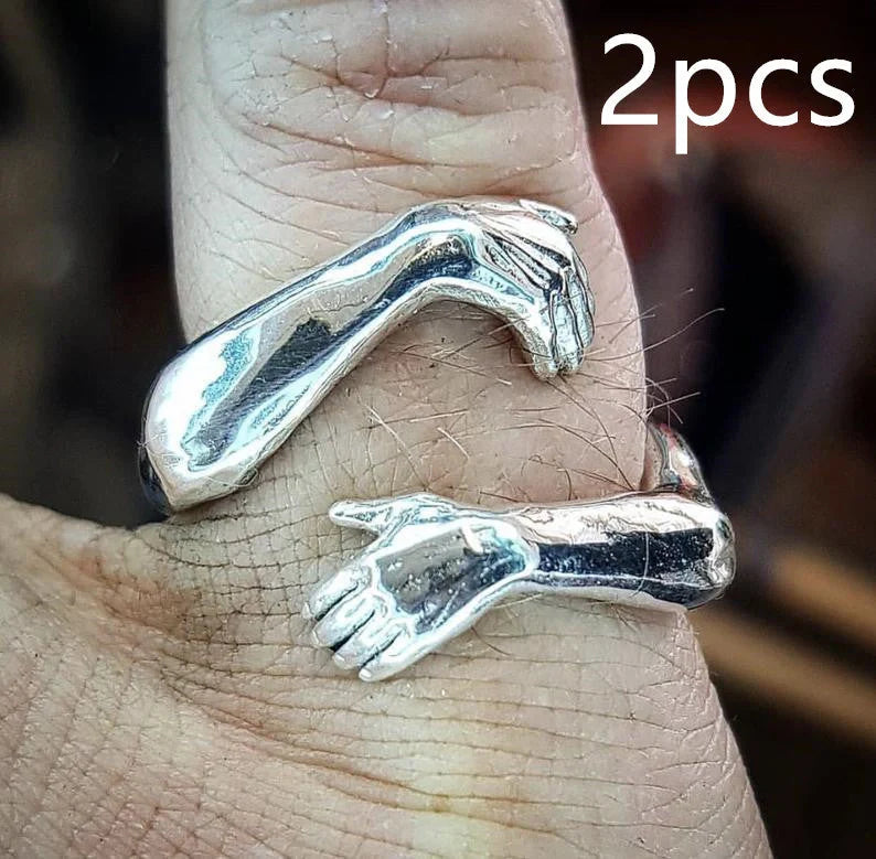 Elegant Adjustable Love Hands Embracing Ring in gold and silver, a perfect symbol of affection