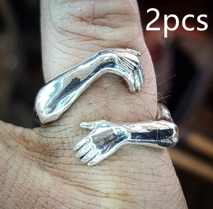 Elegant Adjustable Love Hands Embracing Ring in gold and silver, a perfect symbol of affection