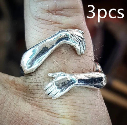 Elegant Adjustable Love Hands Embracing Ring in gold and silver, a perfect symbol of affection