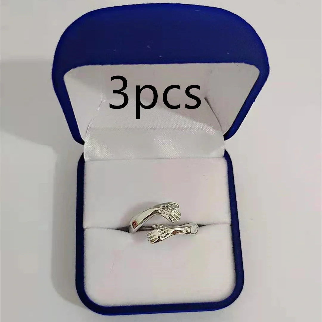 Elegant Adjustable Love Hands Embracing Ring in gold and silver, a perfect symbol of affection