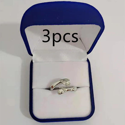 Elegant Adjustable Love Hands Embracing Ring in gold and silver, a perfect symbol of affection