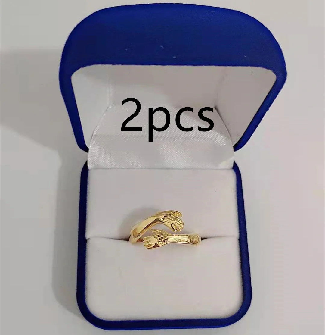 Elegant Adjustable Love Hands Embracing Ring in gold and silver, a perfect symbol of affection