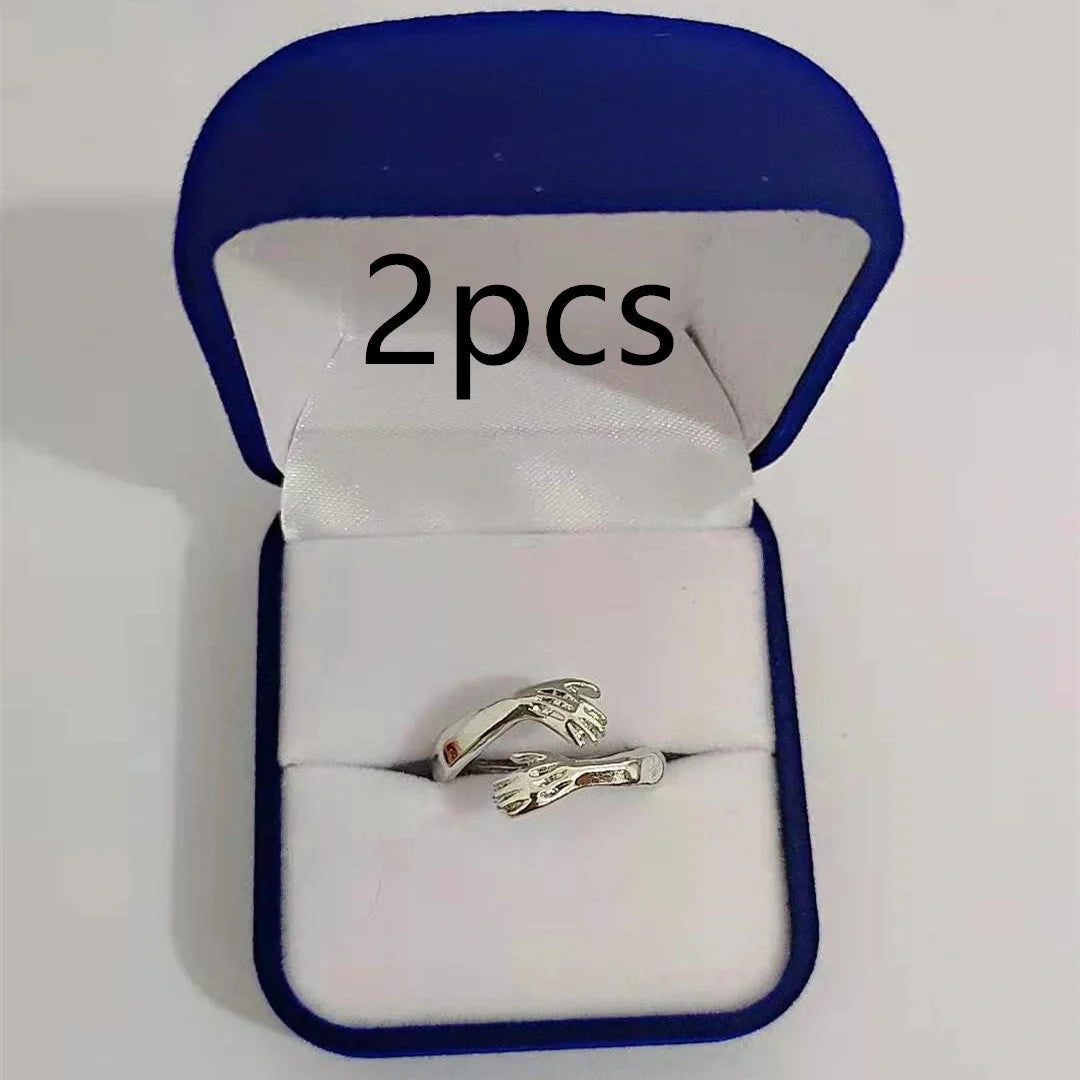 Elegant Adjustable Love Hands Embracing Ring in gold and silver, a perfect symbol of affection