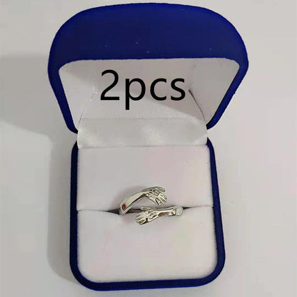 Elegant Adjustable Love Hands Embracing Ring in gold and silver, a perfect symbol of affection