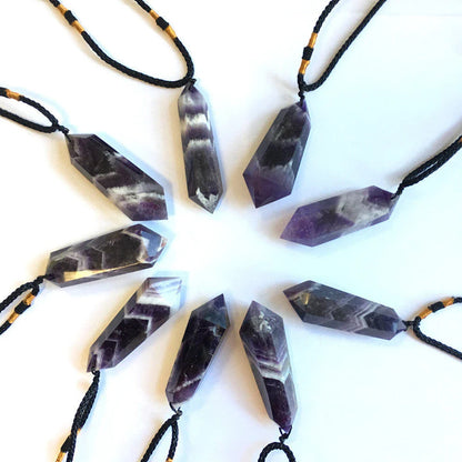 A natural amethyst double-pointed crystal pendant with unique iridescent lines and captivating hues, handcrafted from genuine fluorite quartz.