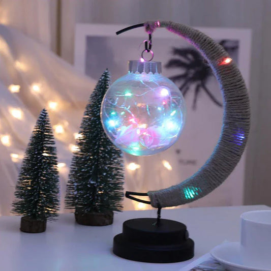Lunar LED Lamp with crescent-shaped holder, emitting warm, soothing light in a variety of colour options