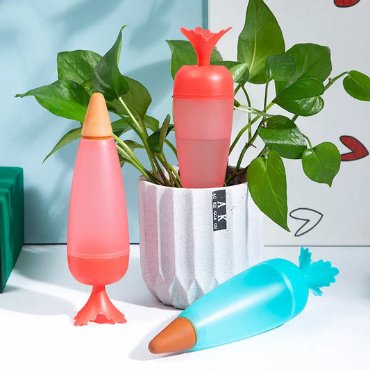 Automatic self-watering plant globes in blue and red colors with transparent design and terracotta bottom