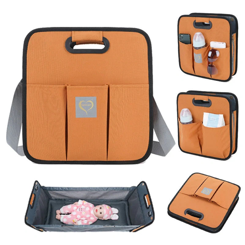 Portable shoulder folding bed baby nappy messenger bag in green, orange, black, and light grey