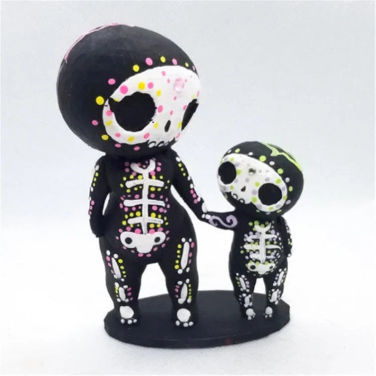 Customisable sugar skull couple figurine sitting on a ledge with legs dangling
