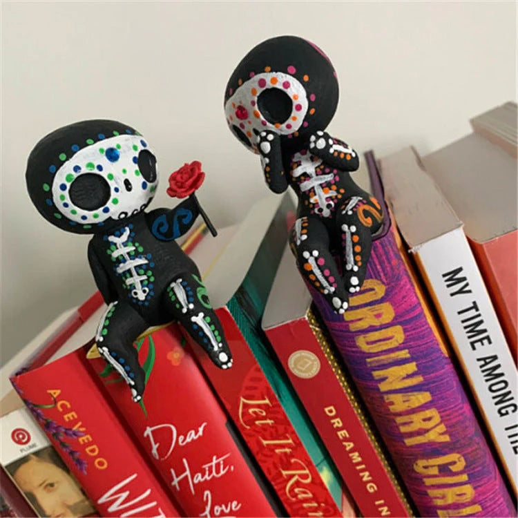 Customisable sugar skull couple figurine sitting on a ledge with legs dangling