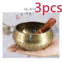 A handcrafted Tibetan singing bowl made of copper, used for meditation and relaxation.