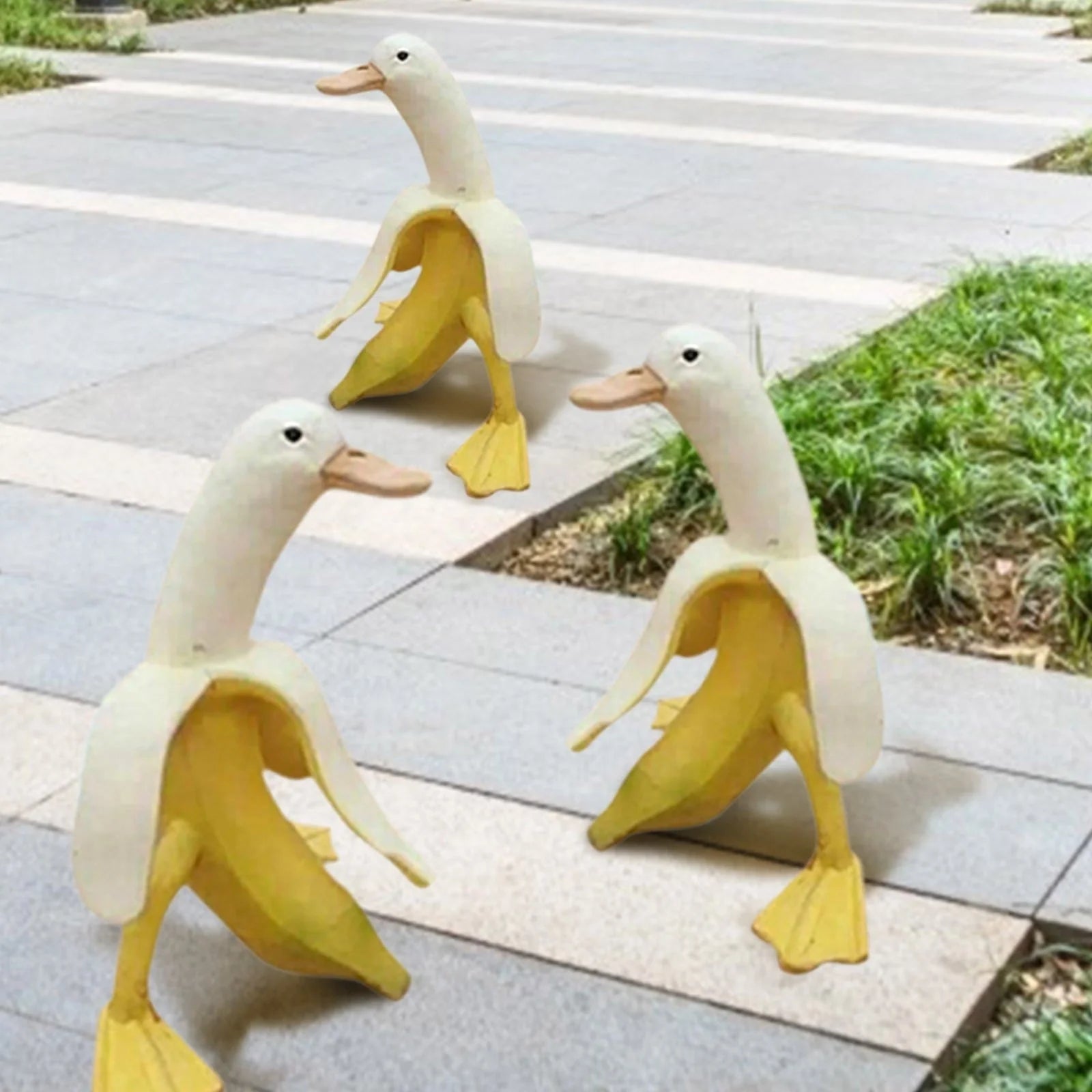 Banana Duck Resin Garden Ornament with vibrant yellow colour and cartoon design