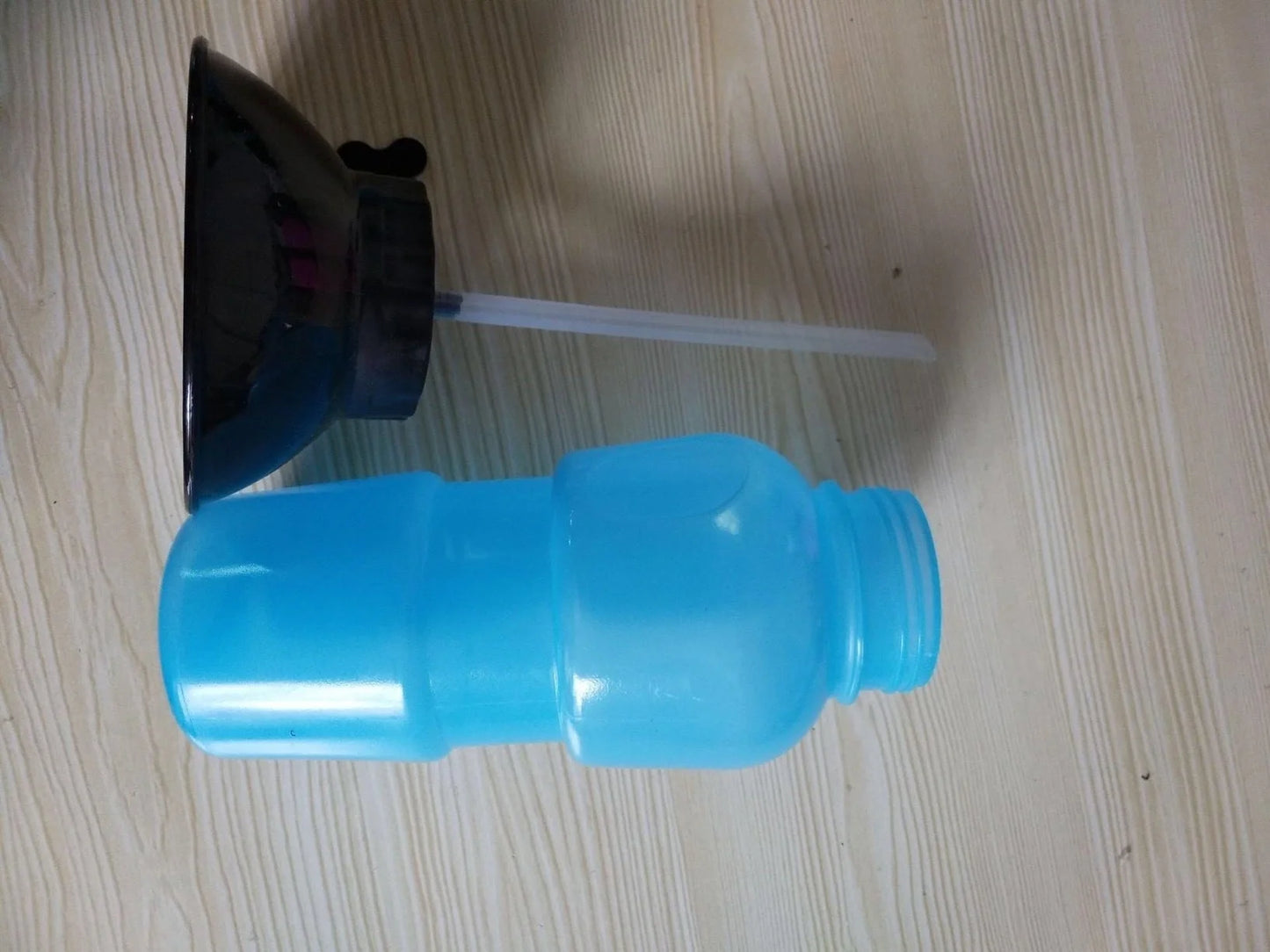 Portable pet water bottle with squeeze-feed bowl for dogs and cats