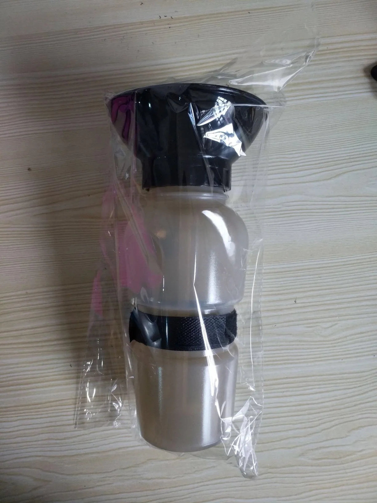 Portable pet water bottle with squeeze-feed bowl for dogs and cats