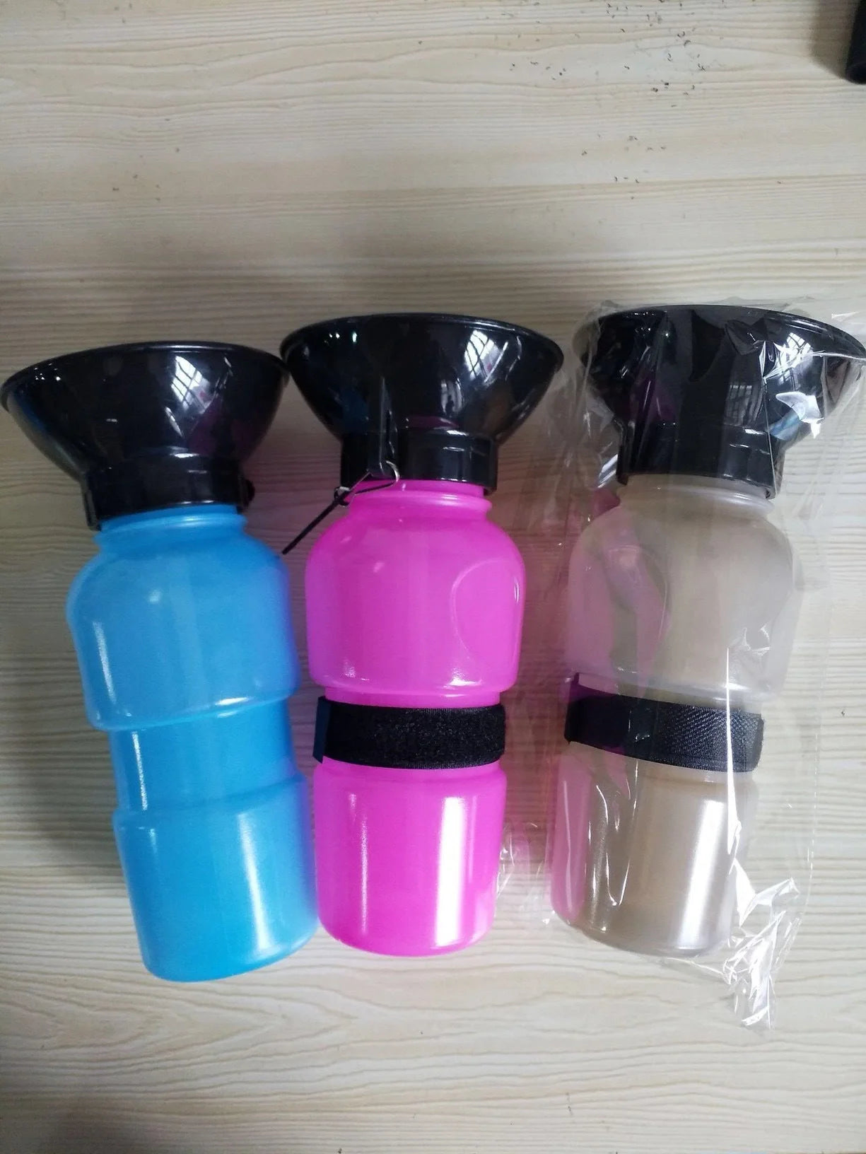 Portable pet water bottle with squeeze-feed bowl for dogs and cats