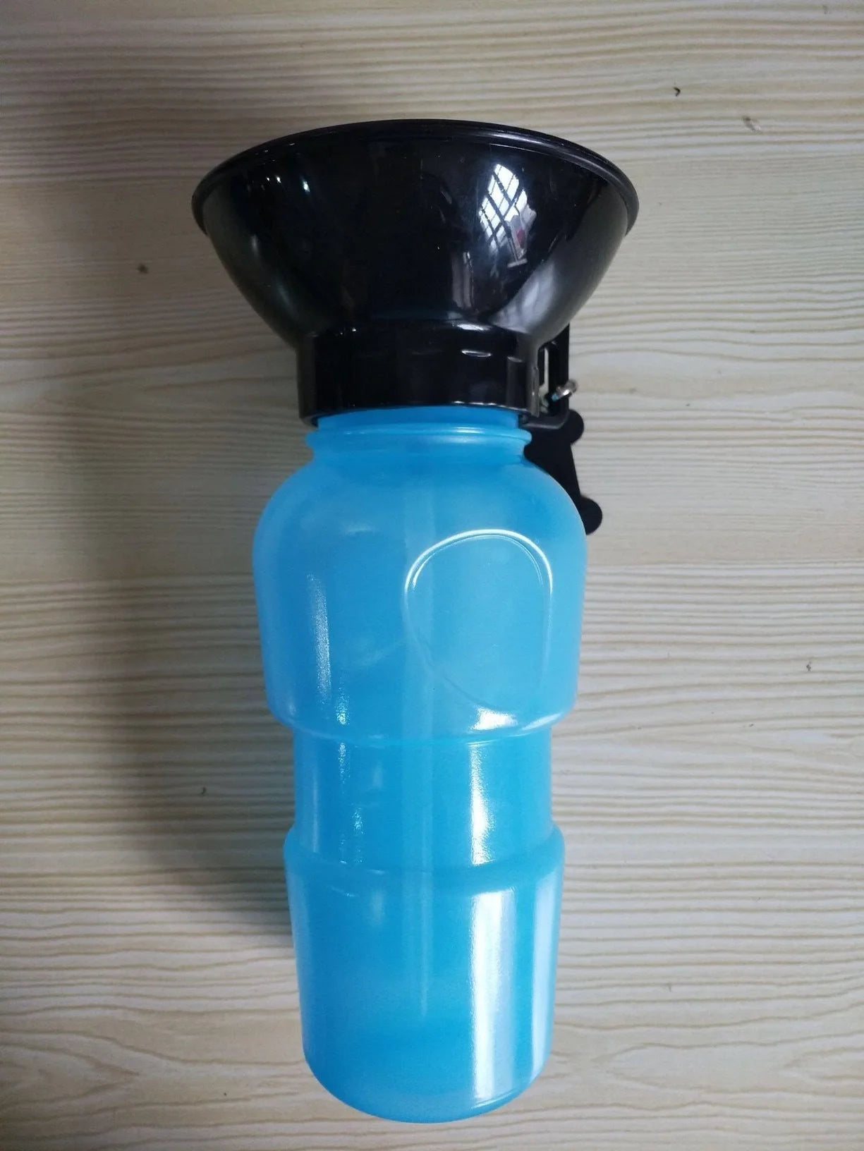 Portable pet water bottle with squeeze-feed bowl for dogs and cats