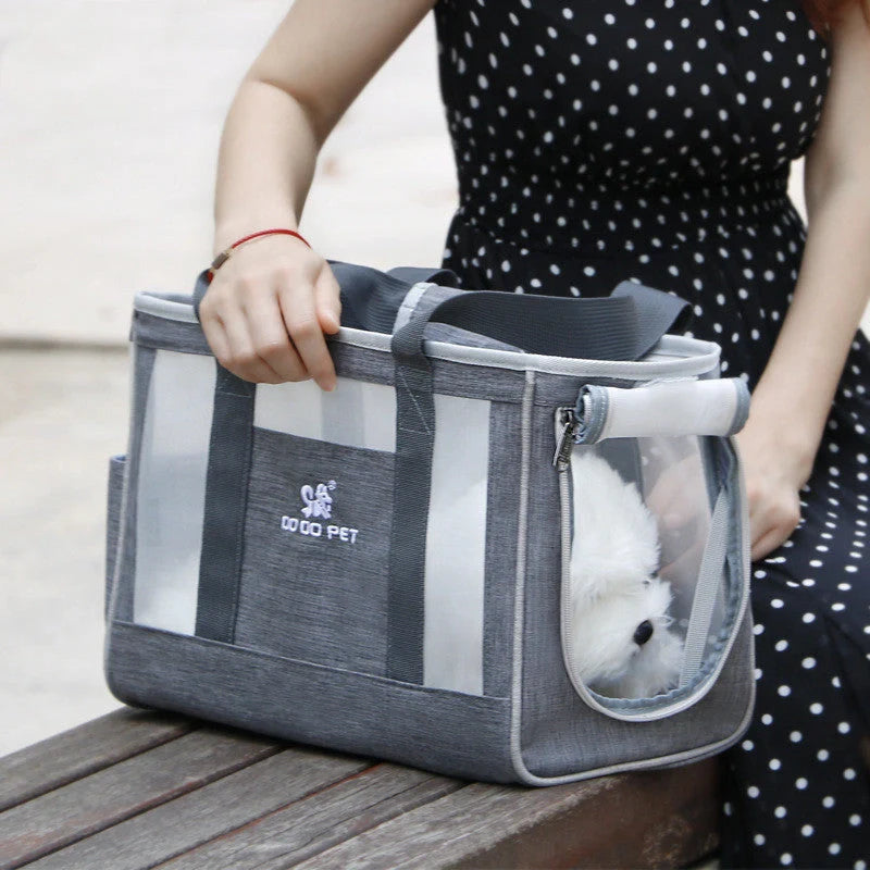 Portable pet carrier backpack in grey, pink, and blue with breathable mesh and large capacity