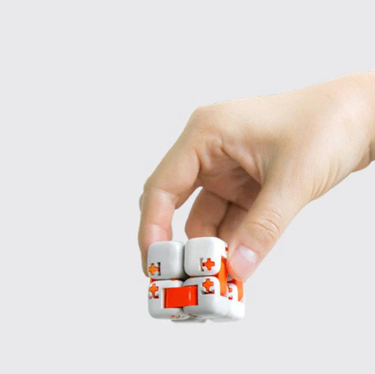 Mitu fidget building block puzzle in white, grey, and orange for stress relief and creative play