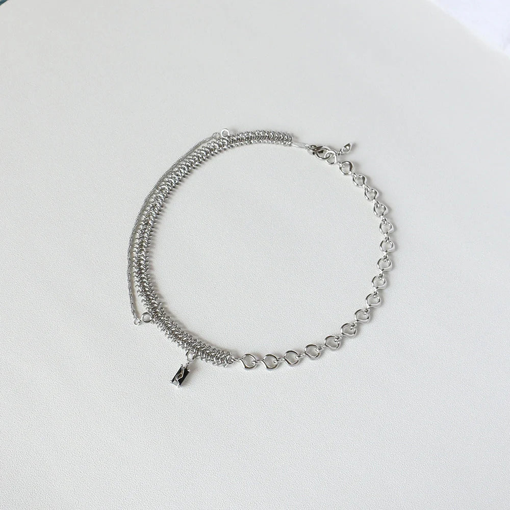 Elegant platinum-plated clavicle chain necklace with a delicate, frosty finish, perfect for adding refined glamour to any outfit.